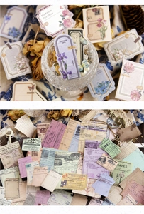 Macro detail of vintage scrapbook kit featuring floral labels and retro paper ephemera set