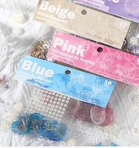 Macro view of gold foil butterfly stickers in three thematic wax seal style sets