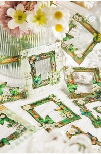 Close-up of vintage butterfly frame PET stickers with floral and manuscript patterns