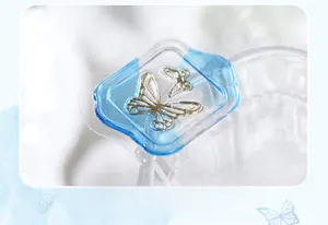 Macro view of clear gold-stamped butterfly seal sticker with intricate blue border detail