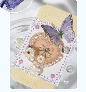 Detailed macro view of purple gradient butterfly and pearl heart DIY decorative sticker