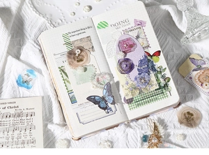 Detail shot of vintage 3D butterfly stickers and gold wax seal stamps for DIY journaling