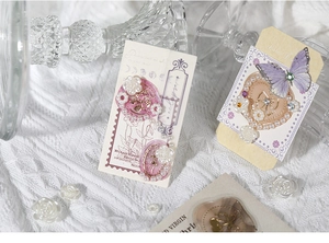 Close-up of vintage floral stickers with 3D pearls, purple butterflies and wax seal charms