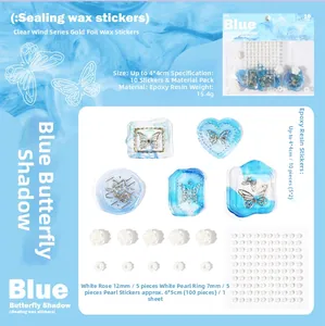 DIY scrapbooking kit with blue butterfly stickers, rose charms, and pearls on a blue wave background