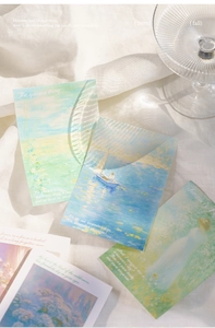 Macro shot of Impressionist oil painting art cards on white fabric with natural shadows