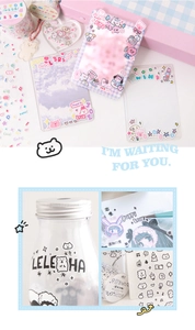 Close-up of cute cartoon bear stickers and pastel stationery for scrapbooking