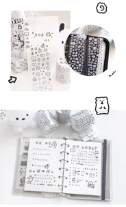 Detail of minimalist black and white line art washi tape featuring cats and bear patterns