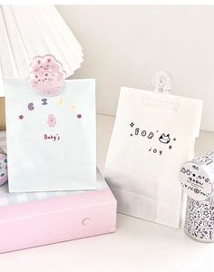 Close-up of cute cartoon acrylic clips for gift bag sealing and DIY scrapbooking