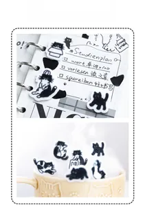 Close-up of black and white felt cat stickers used for creative journaling decoration
