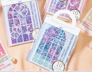 Macro detail of transparent PVC cards with floral and butterfly scrapbooking designs