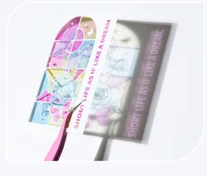 Detail of baroque PVC sticker with butterfly and rose pattern shown with tweezers