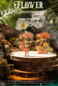 Detail of floral fairy PET stickers with gold foil accents on natural wood and moss