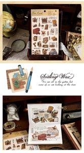 Macro shot of vintage scrapbooking stickers featuring typewriters and nostalgic cameras