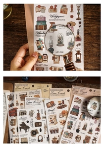 Close-up of vintage scrapbook stickers featuring typewriters and musical instruments