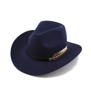Detail of navy felt western cowboy hat with a gold feather buckle and black ribbon band