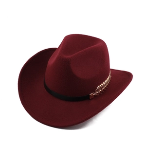 Close-up of wine red wool felt cowboy hat with black leather band and gold metal leaf detail