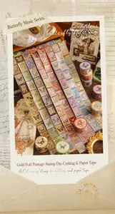 Detail of vintage gold-stamped postage stamp washi tape with butterfly designs