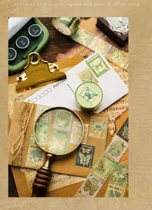 Close-up of vintage butterfly stamp stickers with gold foil details and washi paper texture