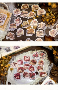 Close-up of vintage aesthetic stickers with roses, old books and romantic envelopes