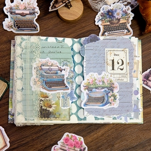 Retro vintage scrapbook stickers with floral and typewriter designs on wooden background
