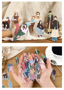 Close-up of vintage PET girl stickers with clear transparency on a rustic wooden table