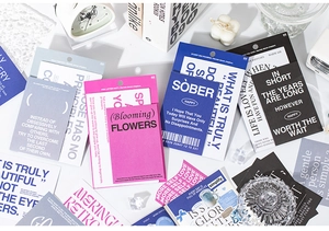 Detail of artistic English quote cards and colorful paper kit for DIY scrapbooking