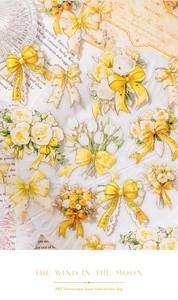Detail of yellow PET stickers with gold-stamped rose bouquets and lace bows for journaling