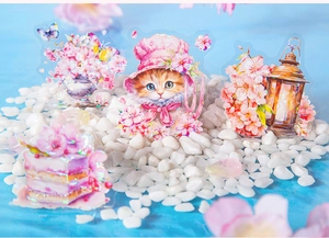 Macro shot of waterproof PET stickers featuring kittens and cherry blossoms with laser finish
