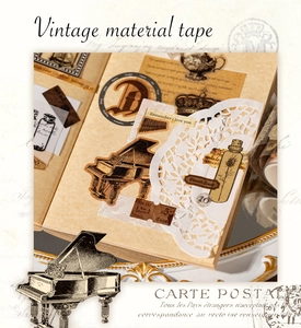 Close-up of vintage journal stickers featuring piano, lace, and retro botanical motifs