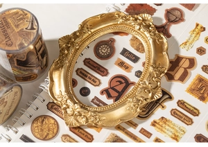 Detailed close-up of vintage theme decorative stickers and washi tapes on a notebook