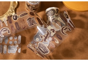 Detailed view of vintage PET washi tape featuring typewriter and quill pen motifs