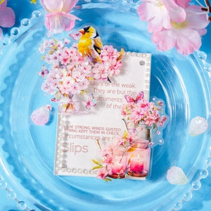 Pink cherry blossom and butterfly DIY stickers in a blue glass plate for journaling
