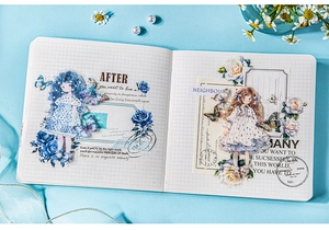 Detail of Butterfly Girl stickers with blue floral motifs on a white grid notebook
