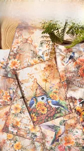 Macro view of vintage paper sheets with detailed bird and floral patterns for journaling