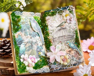Macro detail of bird-themed vintage scrapbooking paper with floral and lace accents