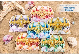 Detail view of decorative seashell jewelry box stickers on sand with pearls