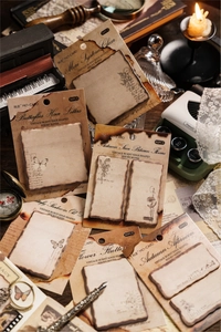 Macro shot of vintage burnt edge sticky notes with butterfly motifs for scrapbooking