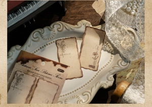 Detailed view of vintage burned-edge floral sticky notes in a classic tea-stained aesthetic