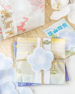 Vintage burnt-edge memo pads with floral designs and rustic twine binding detail
