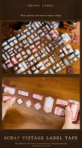Detail of vintage die-cut label stickers and scrapbooking tape on a wooden background