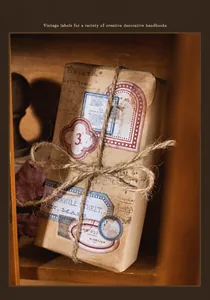 Macro detail of retro die-cut label stickers on kraft box with twine for journaling