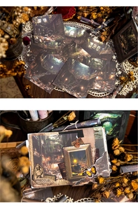 Detail of vintage Wasteland Fantasy decorative paper cards for scrapbooking on wooden desk