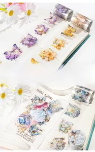 Detailed application of butterfly PET tape and floral stickers on journal pages