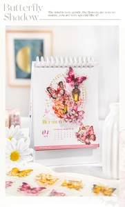 Detailed desk calendar featuring butterfly illustration and spiral binding for 2024