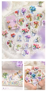 Macro view of floral journaling stickers featuring roses and hydrangeas in vintage glass jars