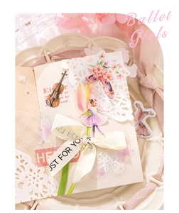 Detail of ballet girls and floral vintage stickers on a notebook for DIY journaling