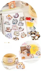 Close-up of hand-drawn cat stickers with ceramic mug and aesthetic stationery set