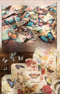 Detailed view of vintage butterfly scrapbooking paper and floral PET stickers on wood