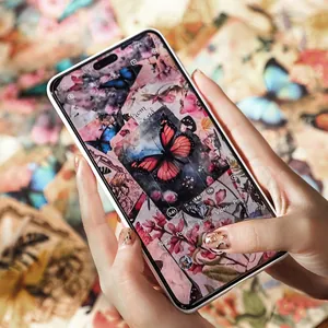 White iPhone Pro case featuring artistic butterfly collage pattern in a lifestyle setting