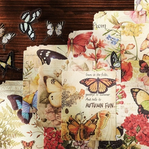 Vintage floral and butterfly decorative paper set for scrapbooking on a rustic wooden desk